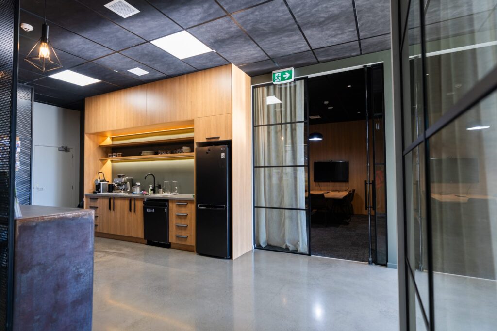 Maugers_Property_Innovation_Park_Drone_Shoot_13_3_26_Small_194 High-quality shared office space with kitchenette and meeting room access inside a modern commercial building at Innovation Park Templeton. Suitable for commercial leasing property needs, tenant management solutions and businesses seeking flexible office space.
