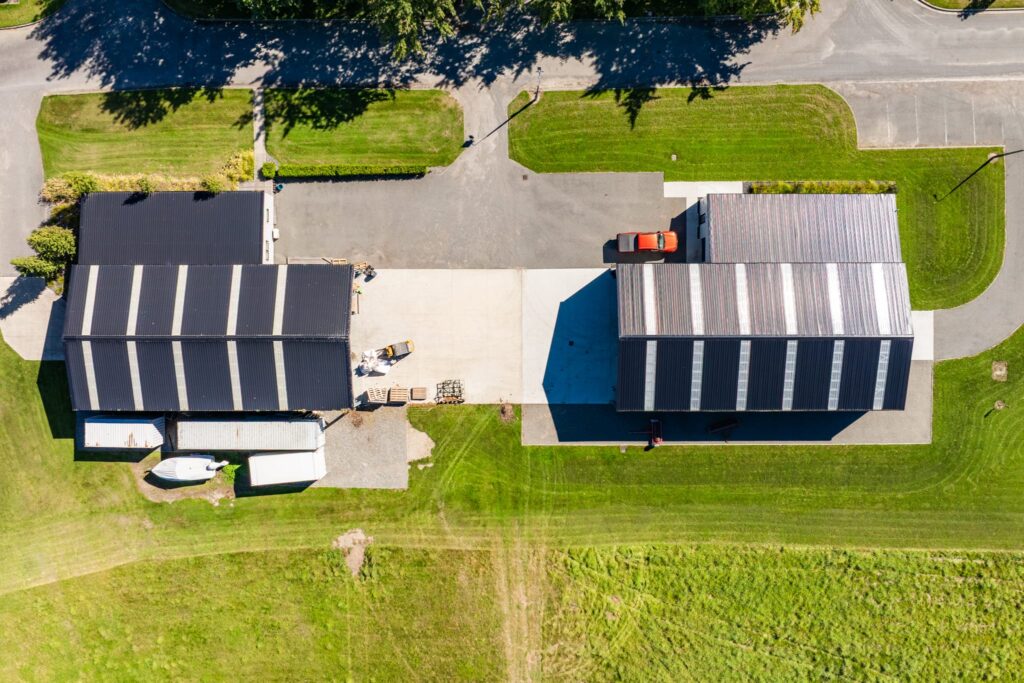 Maugers_Property_Innovation_Park_Drone_Shoot_13_3_26_Small_97 Overhead aerial view of dual commercial building facilities with warehousing, yard space and paved access areas at Innovation Park Templeton. This commercial property suits property investment, business leasing and industrial portfolio growth within a premium Christchurch business estate.